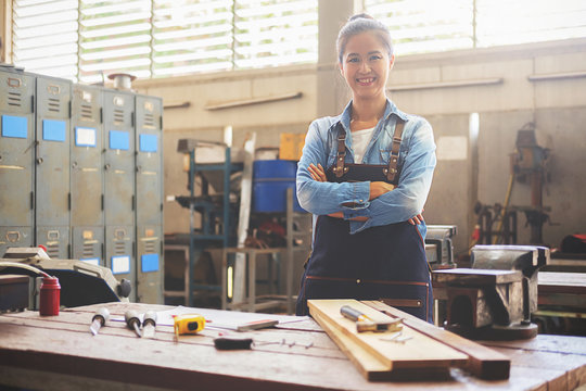 Carpenter on workplace in carpentry workshop.