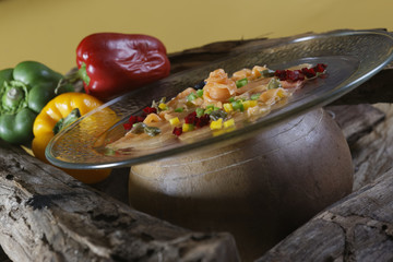 Carpaccio of fresh salmon with pieces of pepper, capers and olive oil. The dish, based on the Piedmont specialty raw meat all'albese, was invented in 1950 by Giuseppe Cipriani.