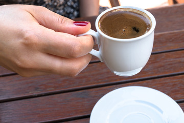 A Woman Holding a Cup of Turkish Coffee