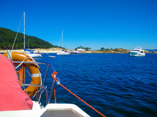Boat diving in front of a beach of Cies Islands, in Galicia, Spain
