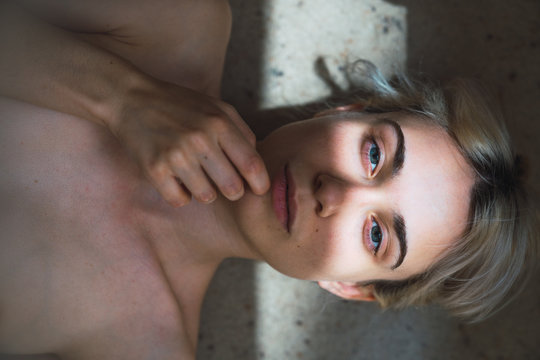 Portrait of young woman lying on floor