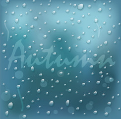 on the glass with the drops of the word autumn