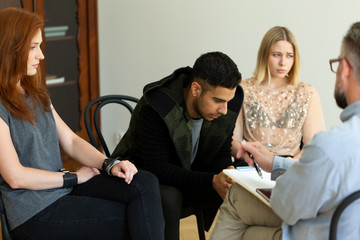 Close-up of a sad hispanic man talking to his therapist about depression and suicide thoughts...