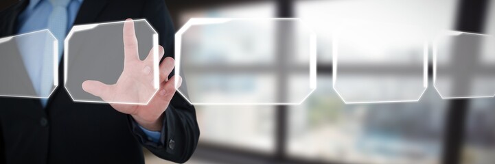 Mid section of businessman touching imaginary interface screen