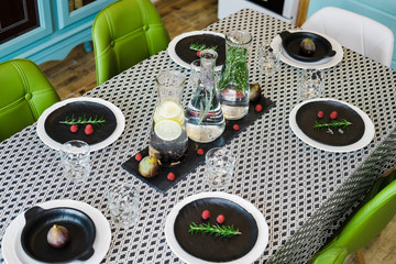 Water in glass decanters with oregano and served table