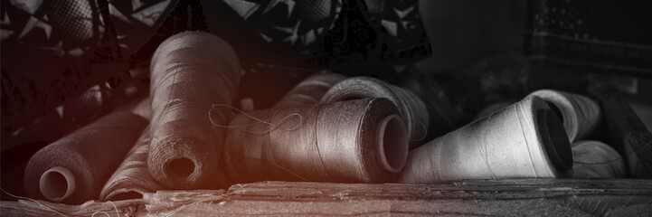 Various spool Of threads arranged on table