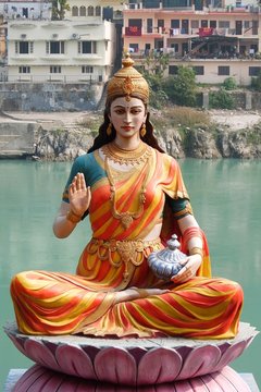 Statue of sitting goddess Parvati on the riverbank of Ganga in Rishikesh
