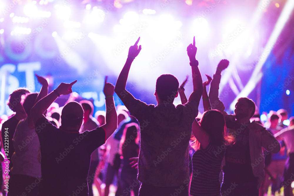 Wall mural bright colorful background with the silhouettes dancing young people during the performance favorite