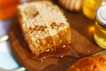 honey honeycomb on wooden plate