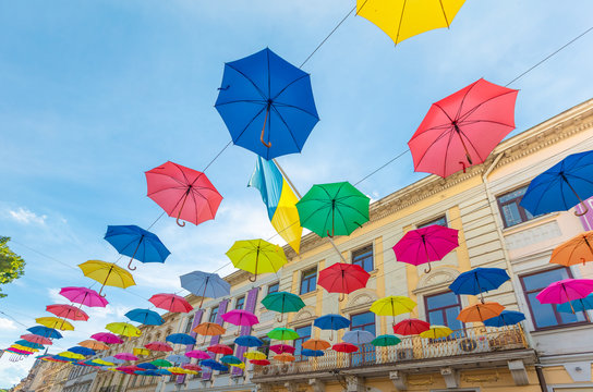 Colorful umbrellas hanging on the street in Lviv