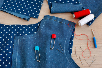 The process of sewing clothes. Clothes are cut from denim. Tailoring and fashion. Thread coils,...