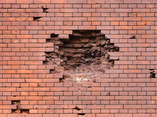 Echoes of war. Wall damaged by a military projectile (bomb), broken red brickwork. Brest fortress,...