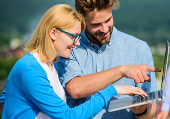 Couple working laptop outdoor sunny day, nature background. Man and girl interested information...