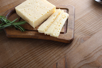 cheese cut on a wooden background