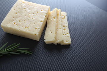 cheese cut on a gray background