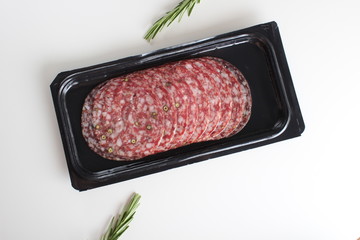 sausage sliced in a package on a white background