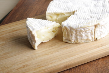 Camembert brie cheese on a wooden background