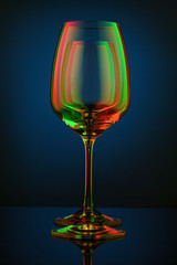 Coloful wineglass on table.