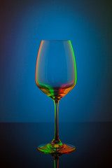 Coloful wineglass on table.