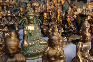 Fototapeta na wymiar Small bronze statuettes on the street market in Rishikesh.