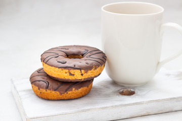 Donuts with chocolate glaze and coffee cup 
