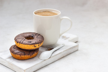 Donuts with chocolate glaze and coffee cup 
