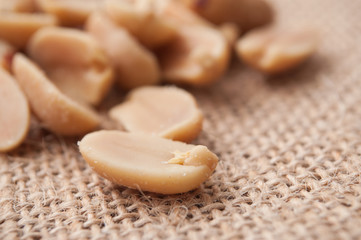 closeup of salted peanuts on hessian background