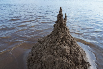 sand castle on the beach against the water