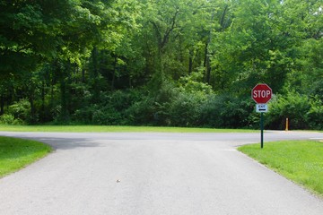 The intersection of the road to the stop sign. 