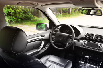 View of the interior of a modern automobile showing the dashboard. Black leather car interior