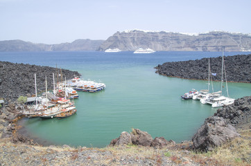 Wooden ships on port of Nea Kameni volcanic island near Santorini