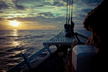 The ocean view from the bow of a sailing ship on the beautiful sunsets