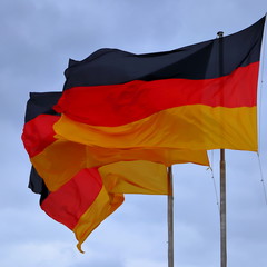 Three flags of Germany, German flag blowing in the wind.