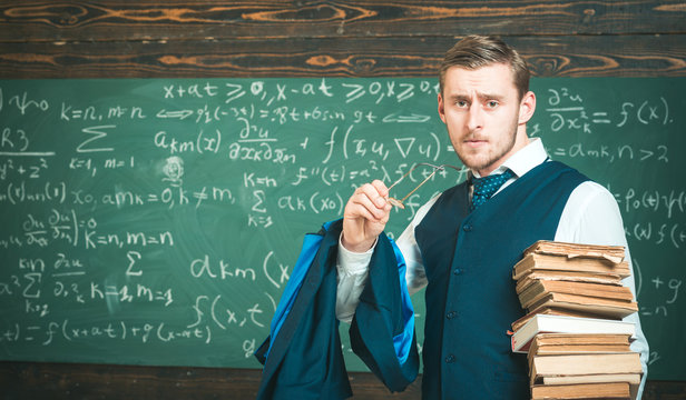 Clear explanation. Teacher formal wear and glasses looks smart, chalkboard background. Man in end of lesson takes off eyeglasses. Teacher finished explanation. Chalkboard full of math formulas