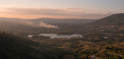 landscape view of lake in mountains at sunrise time with the morning moon on sky