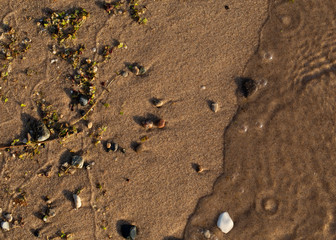 Pebbles on Sand with Wave