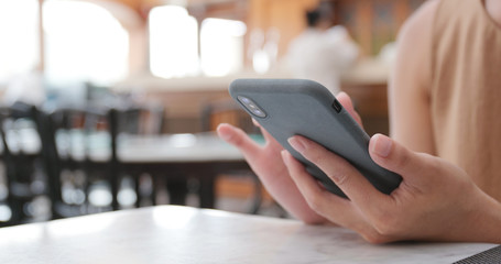 Woman use of cellphone in coffee shop