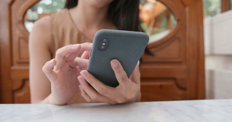 Woman use of cellphone in cafe