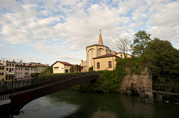 The bell tower and the cathedral of San Niccolò in Sacile on the river livenza. 
Pordenone district, Italy.