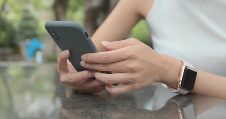 Woman use of smart phone at outdoor cafe
