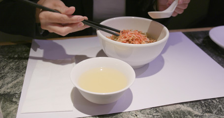 Woman enjoy Chinese ramen in restaurant