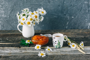 Cup of tea,  flowers, on dark wooden background