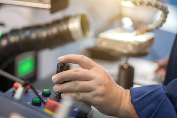 worker working with cnc machine at workshop.