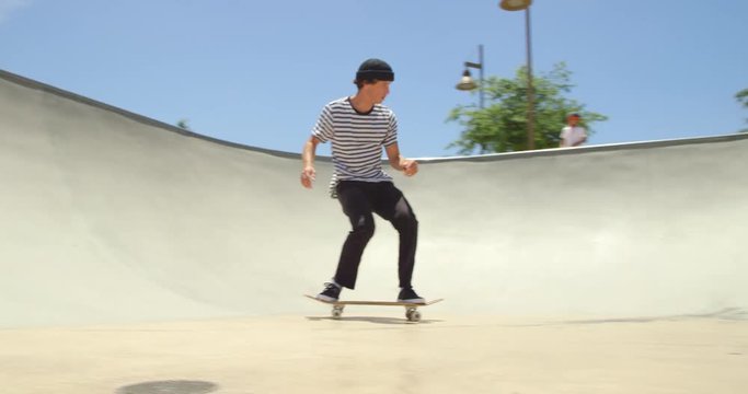 Skateboarder does extreme air off ramp isolated in sky on sunny day 