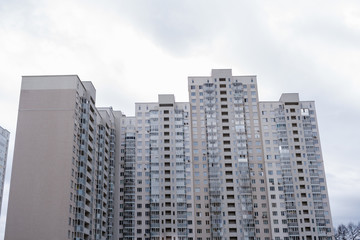 Fototapeta na wymiar Facade of grey multi-storey residential house.