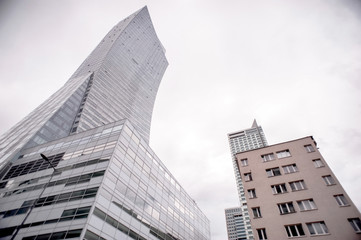 ; view of skyscraper windows; old city in the reflection of a new building;  mixture of glass, metal and concrete;