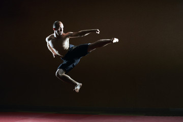 Fototapeta na wymiar One sportsman beats a kick in a jump