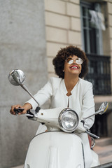 Beautiful girl for afro in the streets of Madrid Spain with motorcycle.