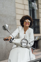 Beautiful girl for afro in the streets of Madrid Spain with motorcycle.