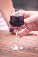 Glass of Red Wine with Caucasian Human Hand
